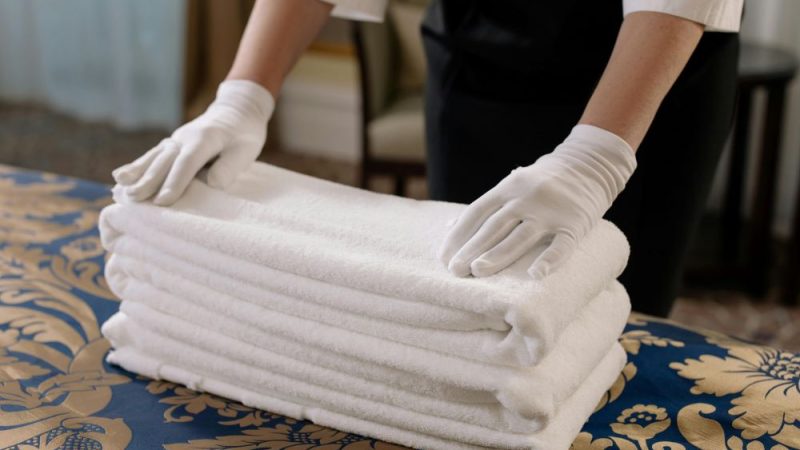 Commercial Cleaning lady folding linen